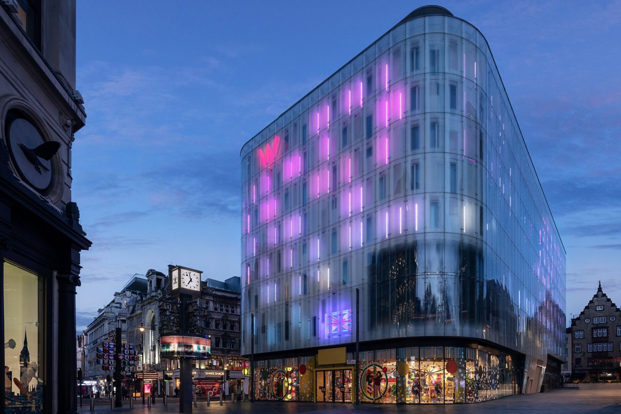 Modern Screening Room at W London, vibrant pink façade, ideal for events and conferences.