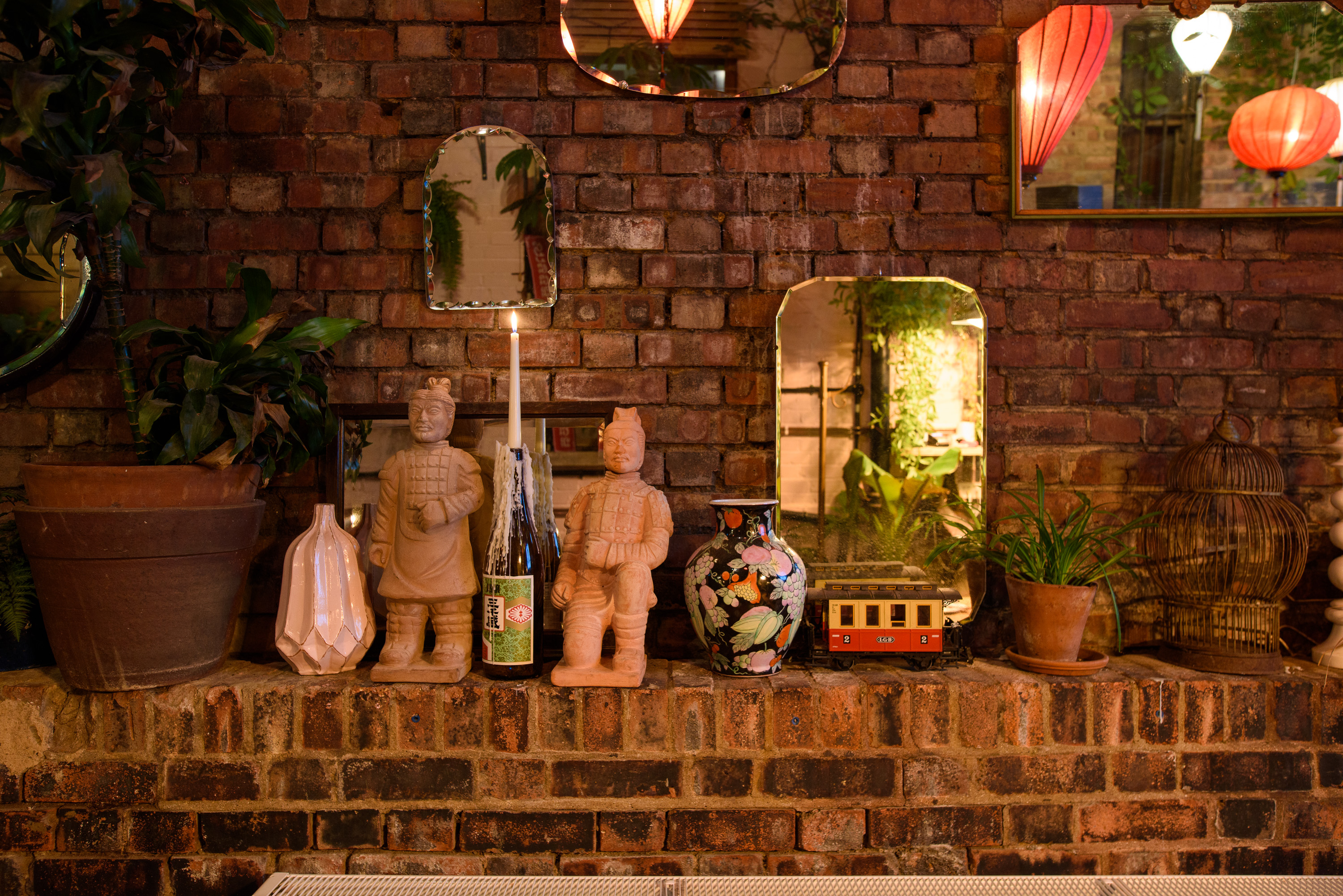 Hanging Garden Room with rustic brick wall, ideal for intimate gatherings and events.