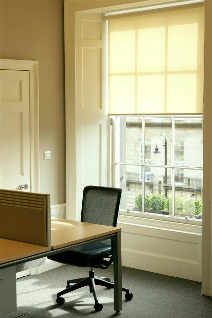 Serviced office meeting space with ergonomic chair, ideal for workshops and brainstorming.