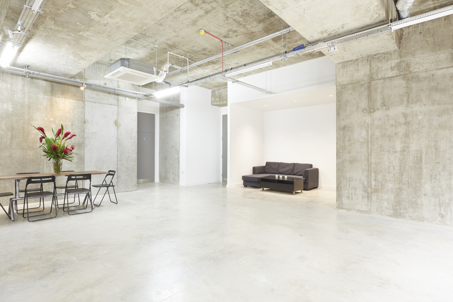 Versatile event space in LOCK Studios with modern industrial design for meetings and gatherings.