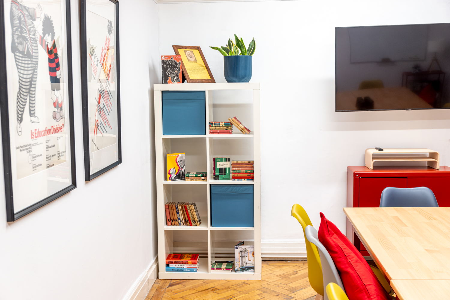 Modern meeting space in Conway Hall with colorful bookshelf for collaborative events.