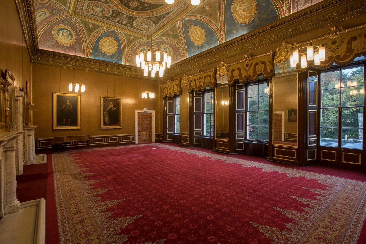 Elegant event space in Newbattle Abbey with ornate ceilings, ideal for formal gatherings.