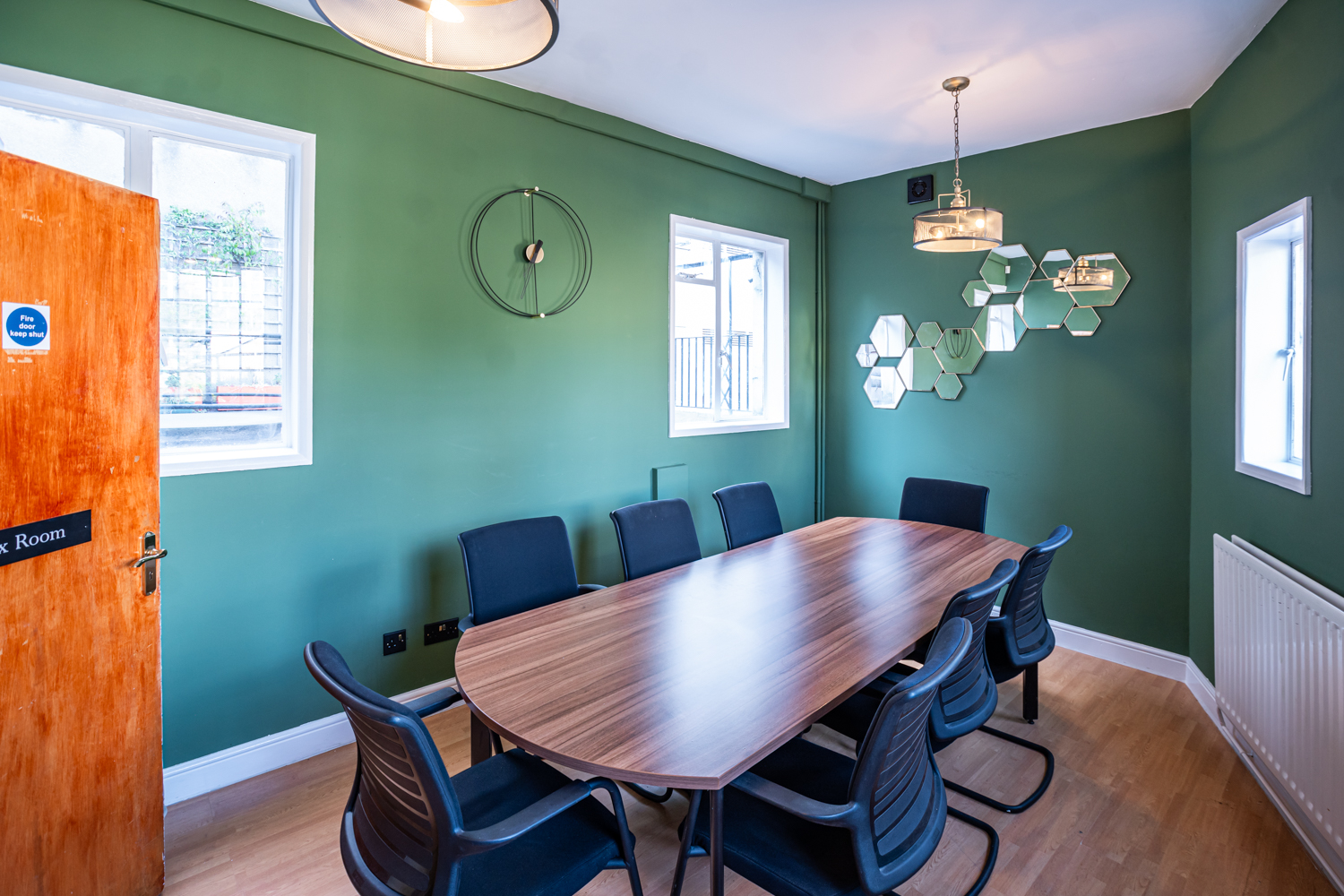 Modern meeting room in Conway Hall with wooden table, ideal for brainstorming sessions.