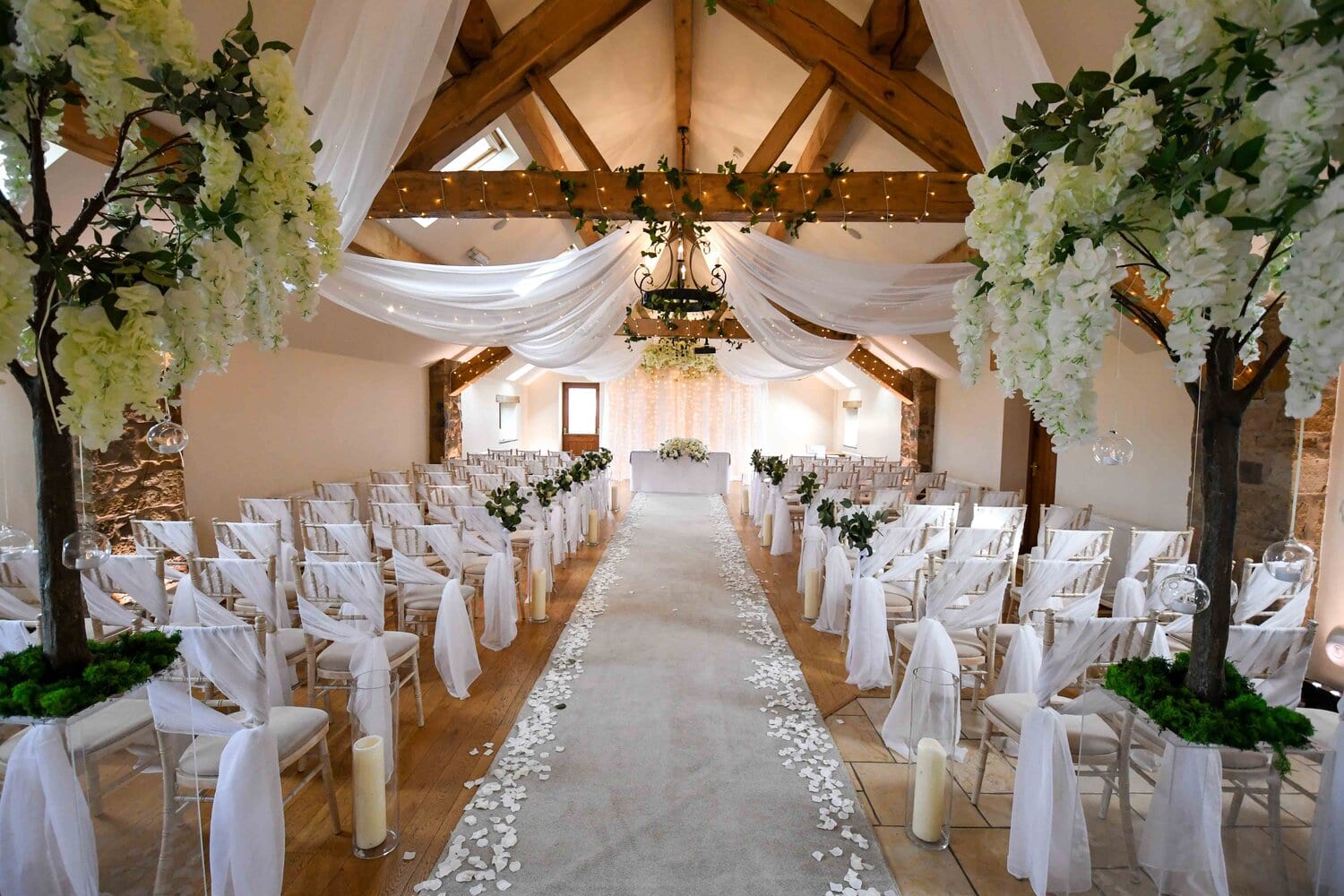 Woodlands Suite at Beeston Manor, elegant wedding venue with floral decor and rose petals.