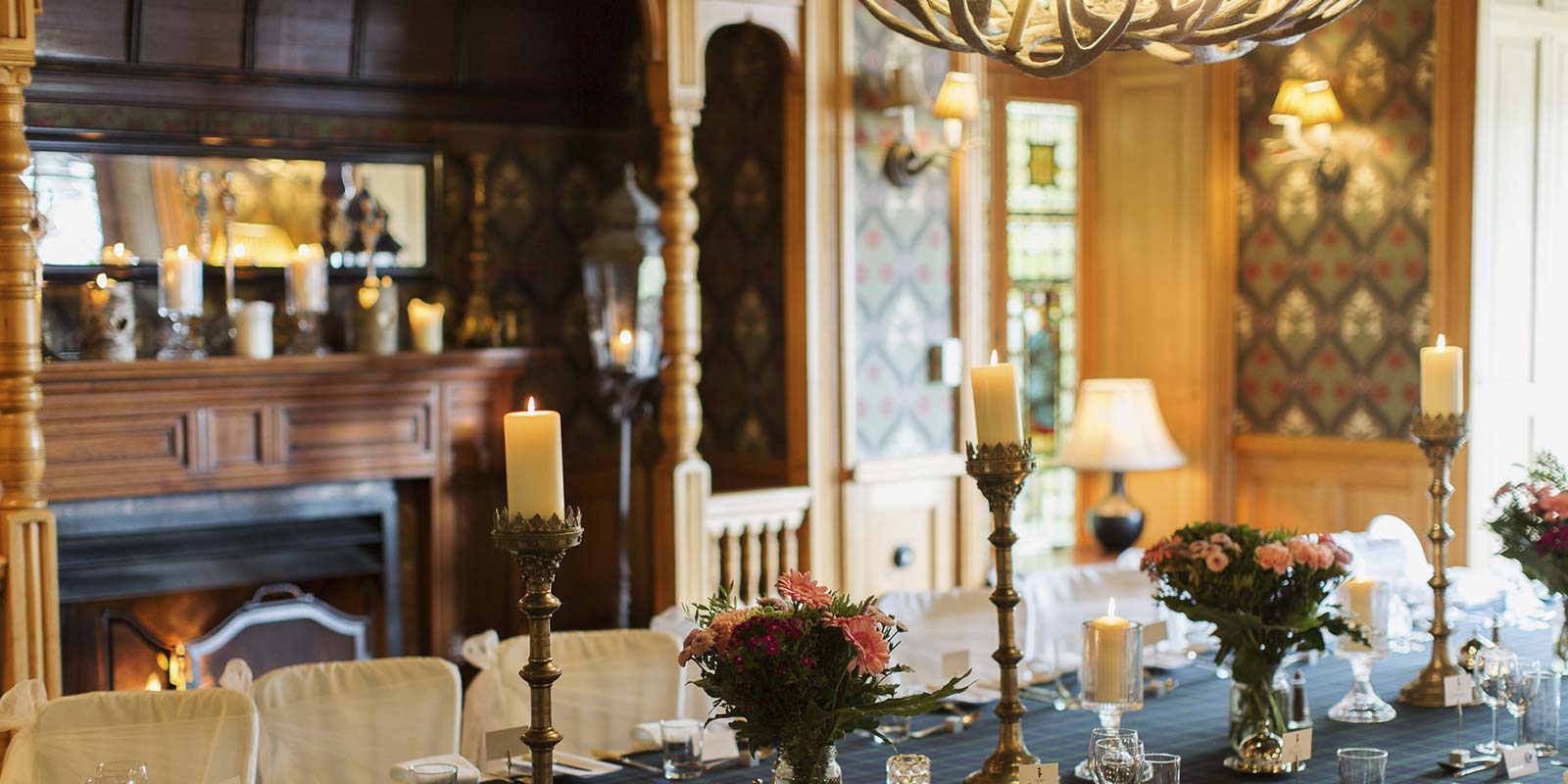 Elegant Arts & Crafts dining room with floral centerpieces for events and gatherings.