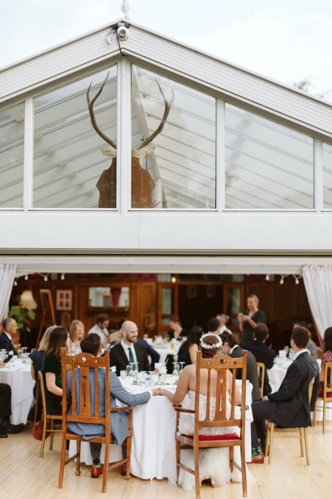 Wedding reception dinner setting at The Conservatory, warm ambiance and intimate decor.