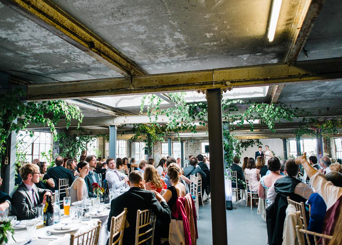 Event space at The Biscuit Factory, featuring greenery for weddings and corporate gatherings.