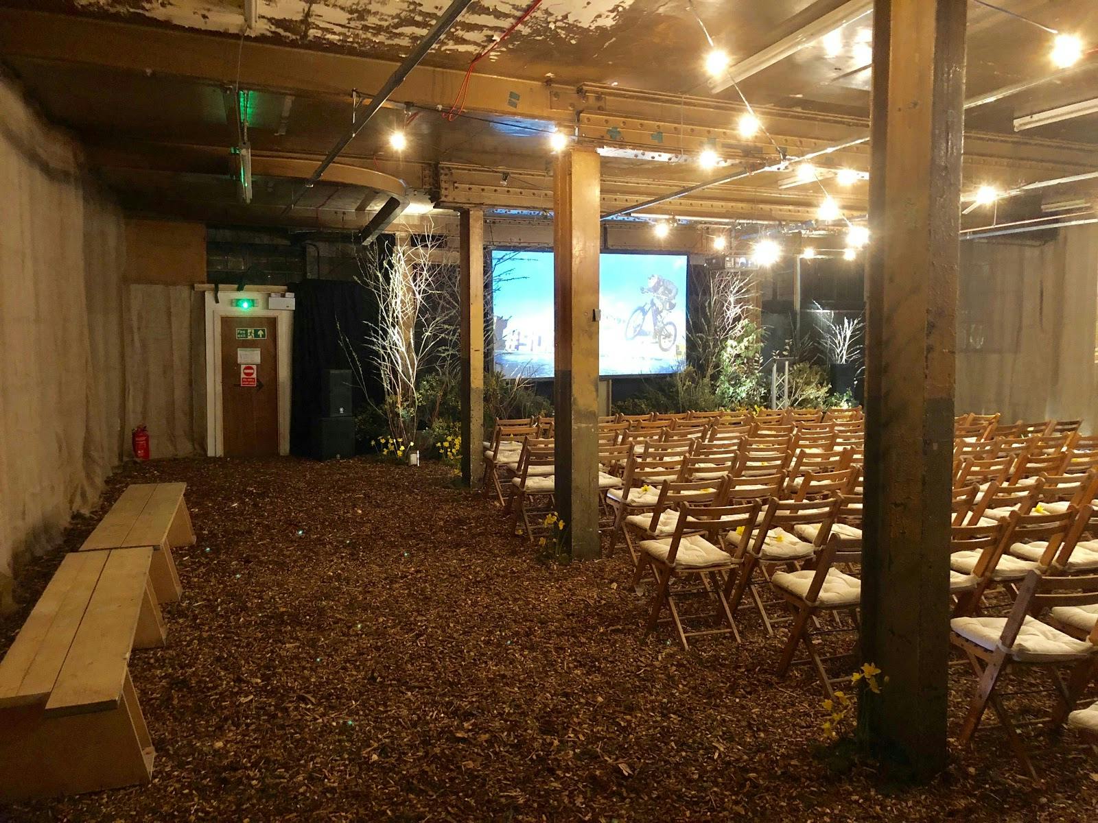 Intimate event space with rustic decor, ideal for seminars and presentations.