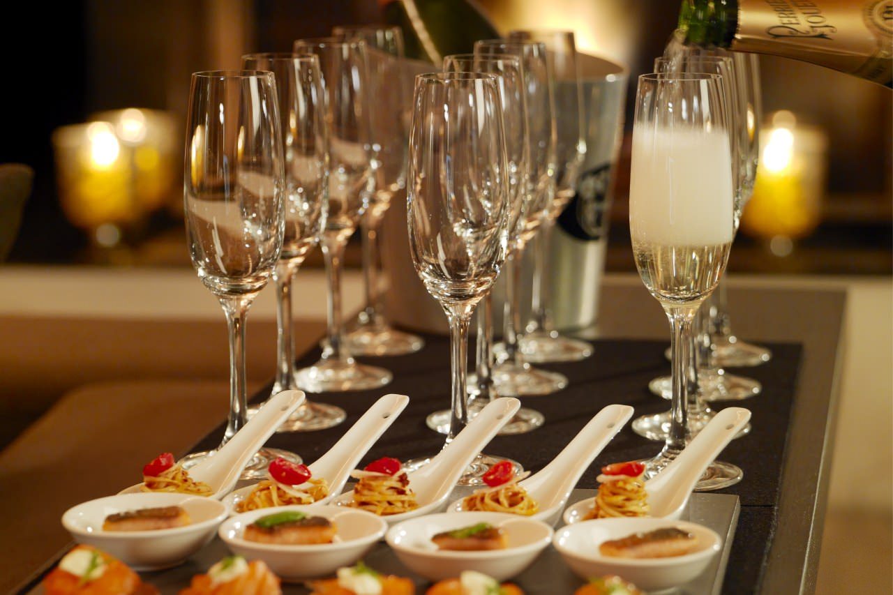 Elegant Madison Room setup with sparkling glasses for networking and celebratory events.