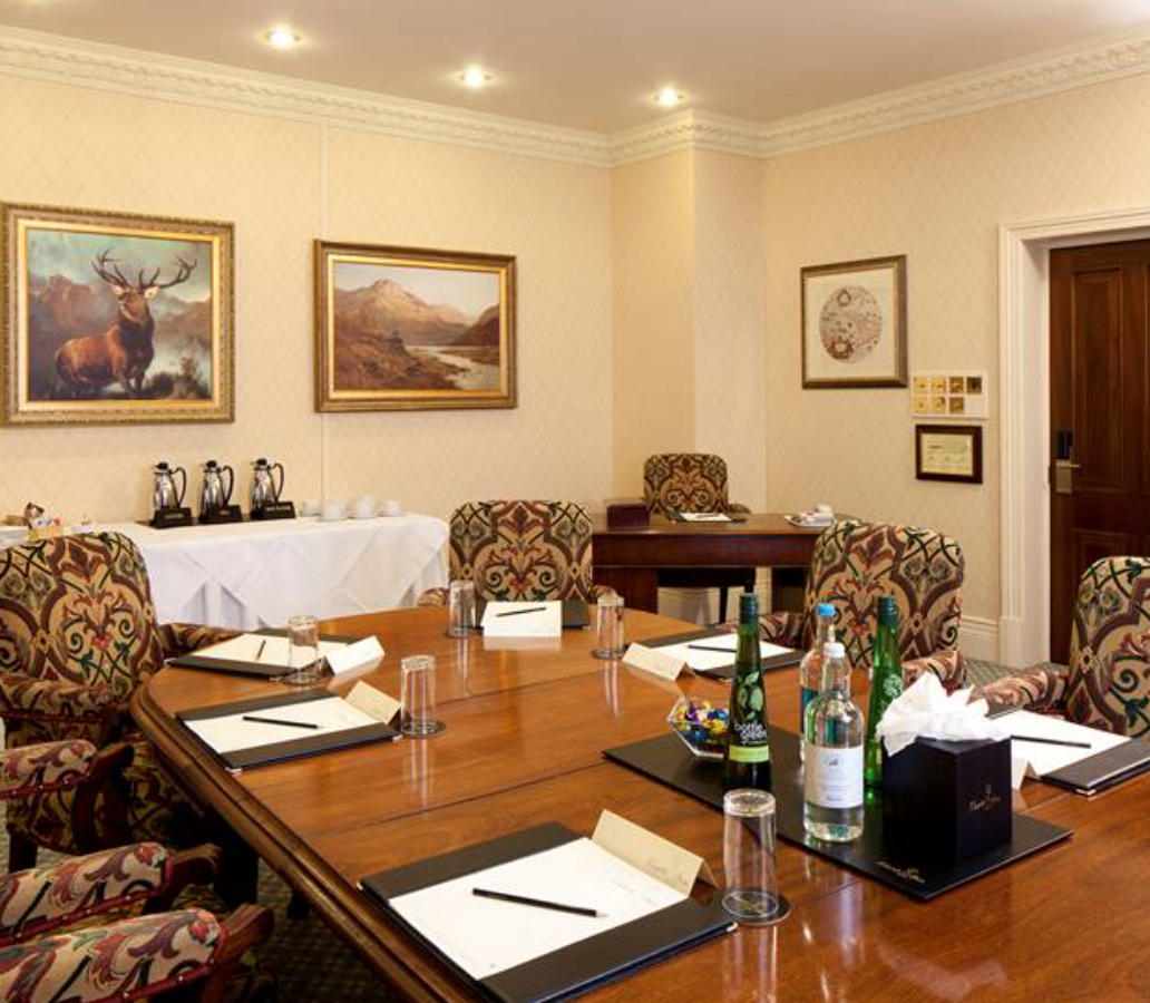 Johnson Room in The Twelfth House, elegant meeting space with wooden table and chairs.