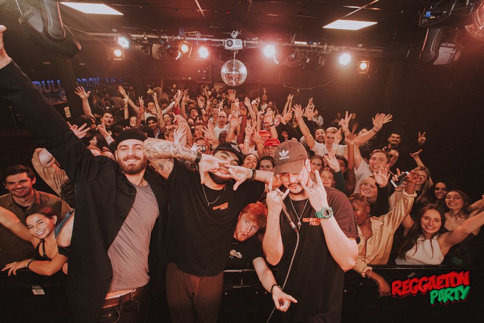 Vibrant crowd enjoying a lively event in La Belle Angele's Main Room.