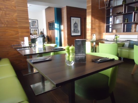 Private dining room with green seating, ideal for networking lunches and small events.