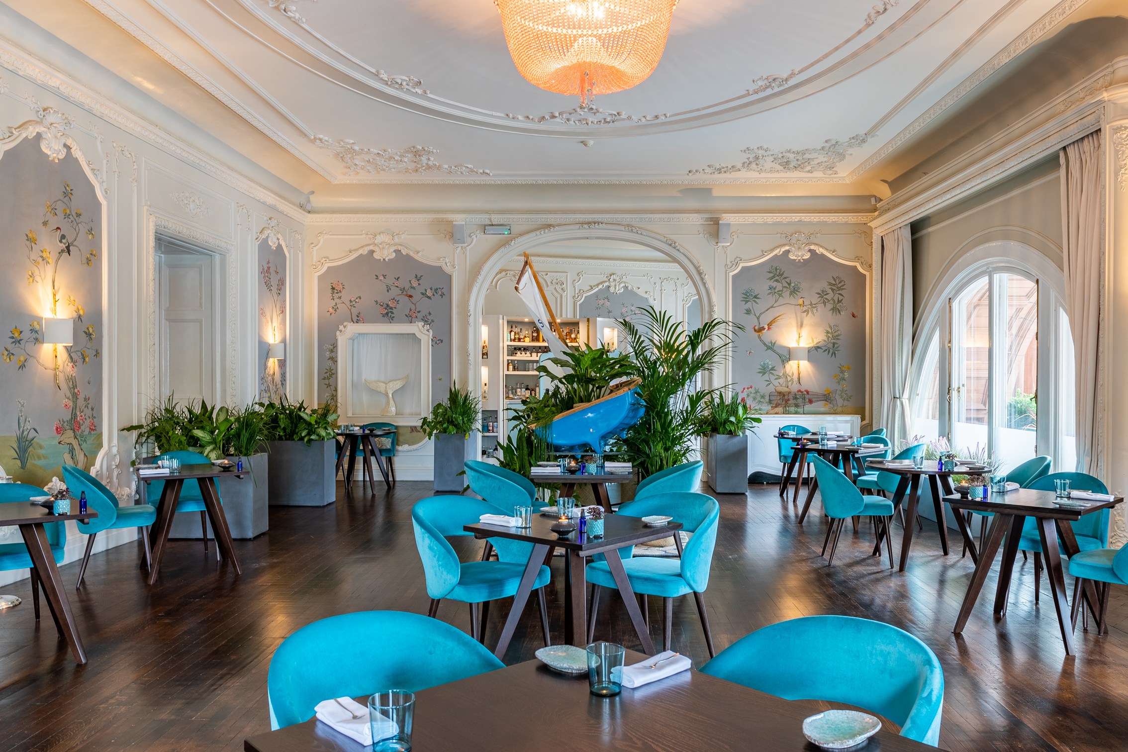 Elegant restaurant The Pompadour with lush greenery, ideal for upscale events and gatherings.