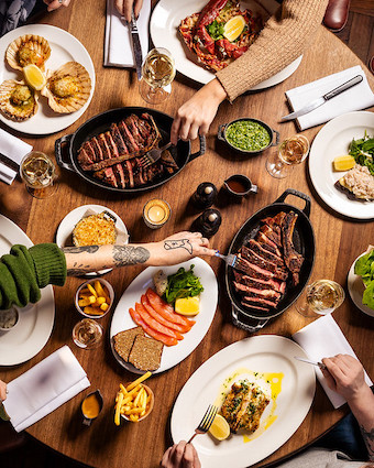 Vibrant dining setup for corporate dinner at Hawksmoor Edinburgh, featuring sliced meats.