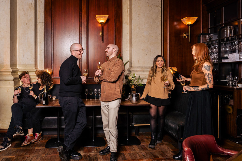 Vibrant networking event in elegant Hawksmoor Edinburgh with stylish decor and warm lighting.