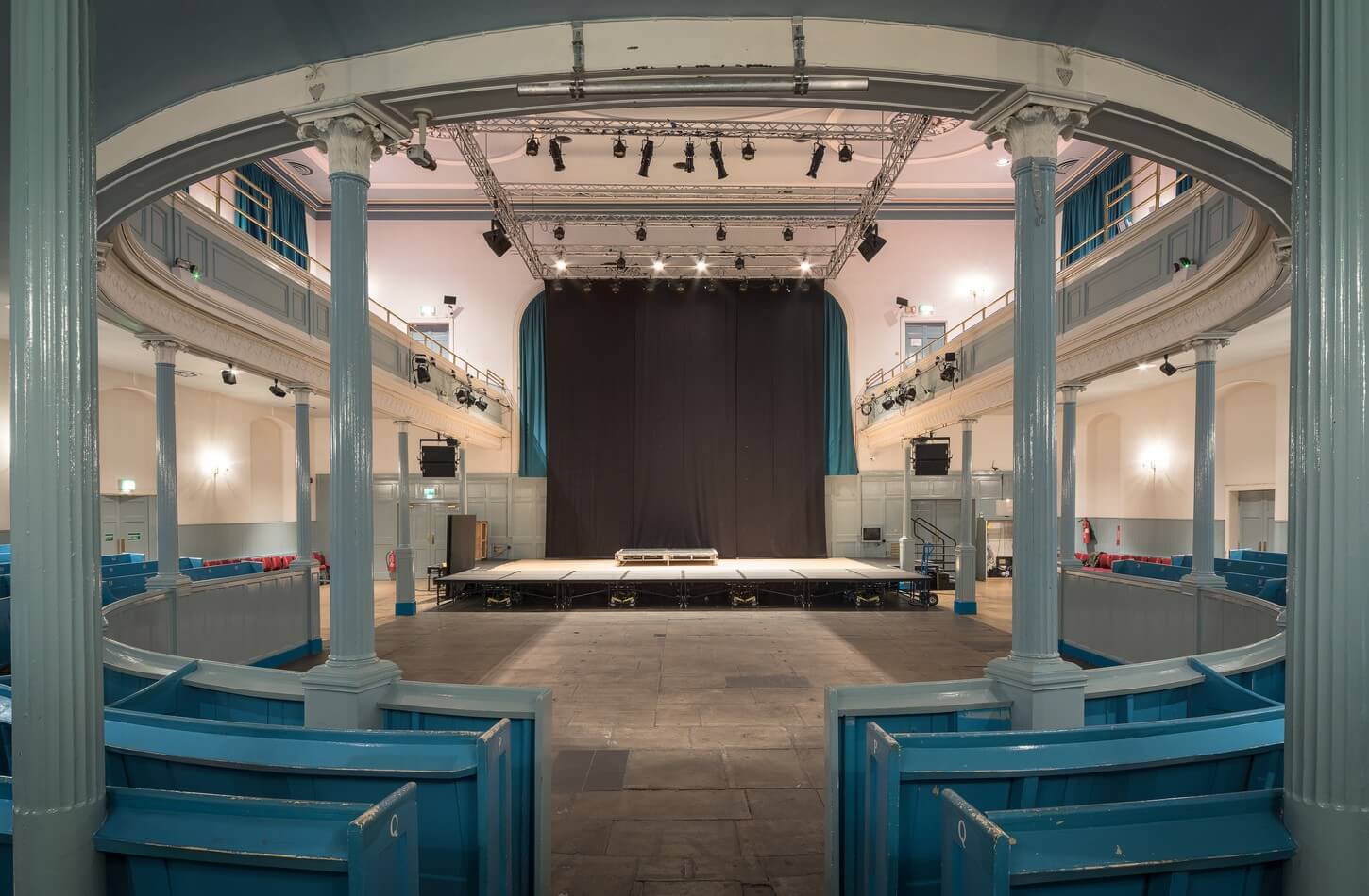 Ground Floor Seating at The Queen's Hall, spacious stage for conferences and performances.