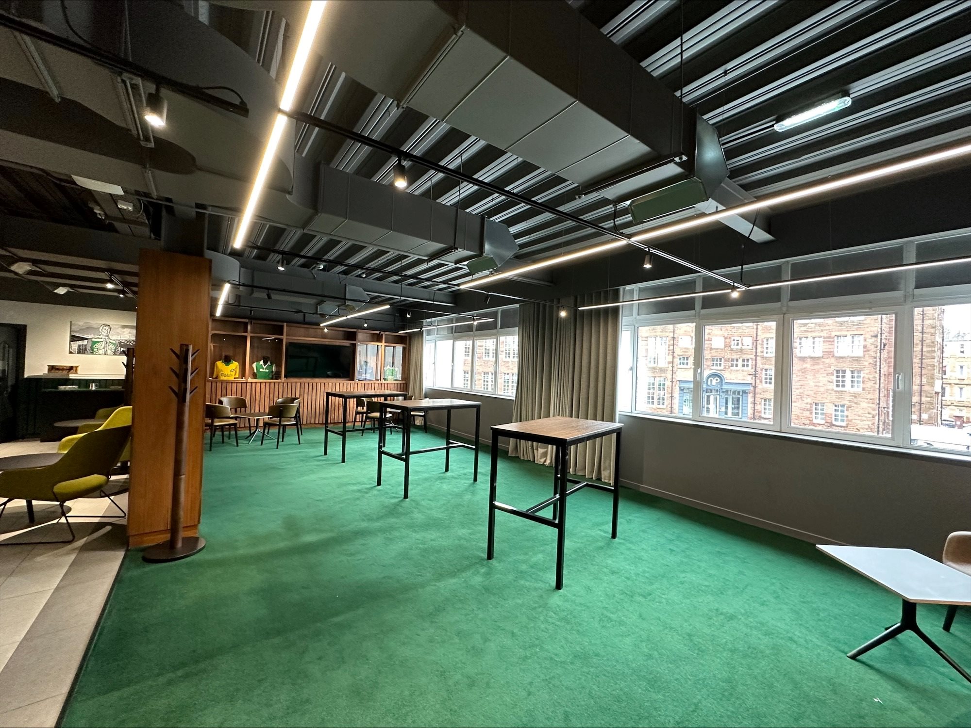 Chairman's Club at Hibernian FC: modern meeting space with vibrant green carpet for workshops.
