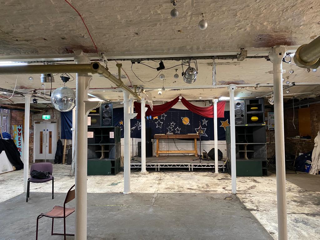 Versatile event space with stage, ideal for live performances and presentations.