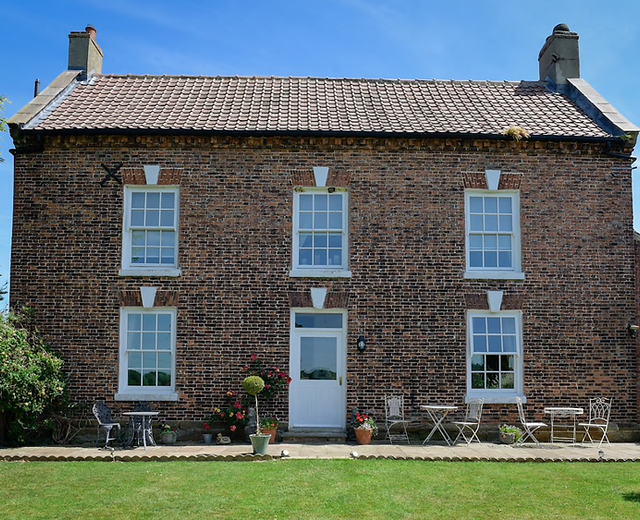Charming brick house at Low Osgoodby Grange, perfect for retreats and networking events.
