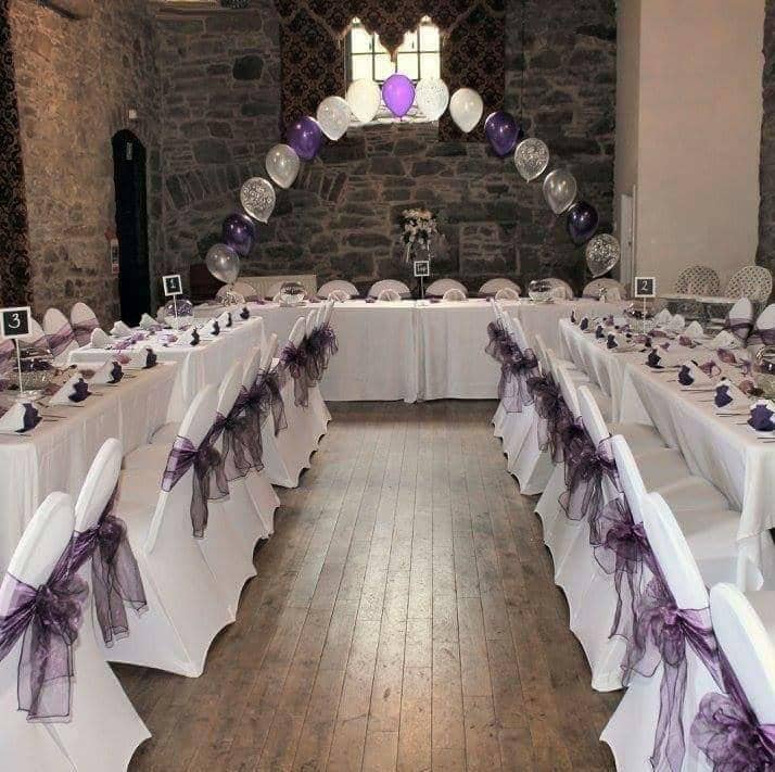 Elegant Mains Castle courtyard with white tables and purple accents for weddings or events.
