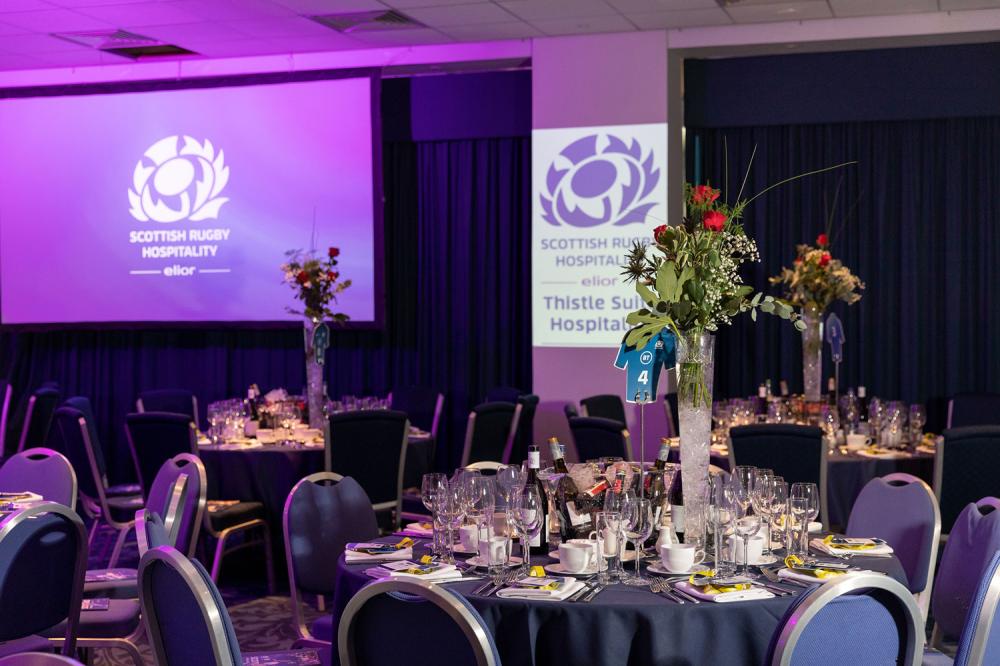 Murrayfield Boxes set for formal corporate event with elegant dining and purple lighting.