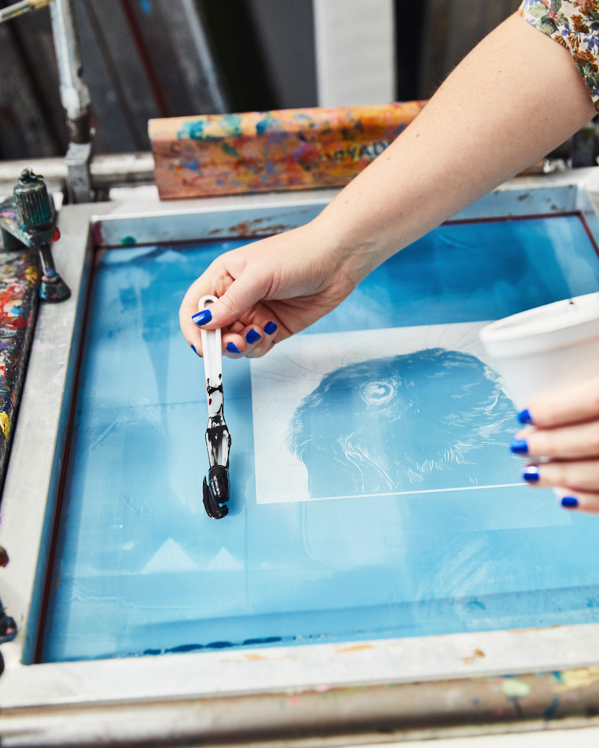 Hand applying ink in The Bluecoat's Garden Room for unique event branding.