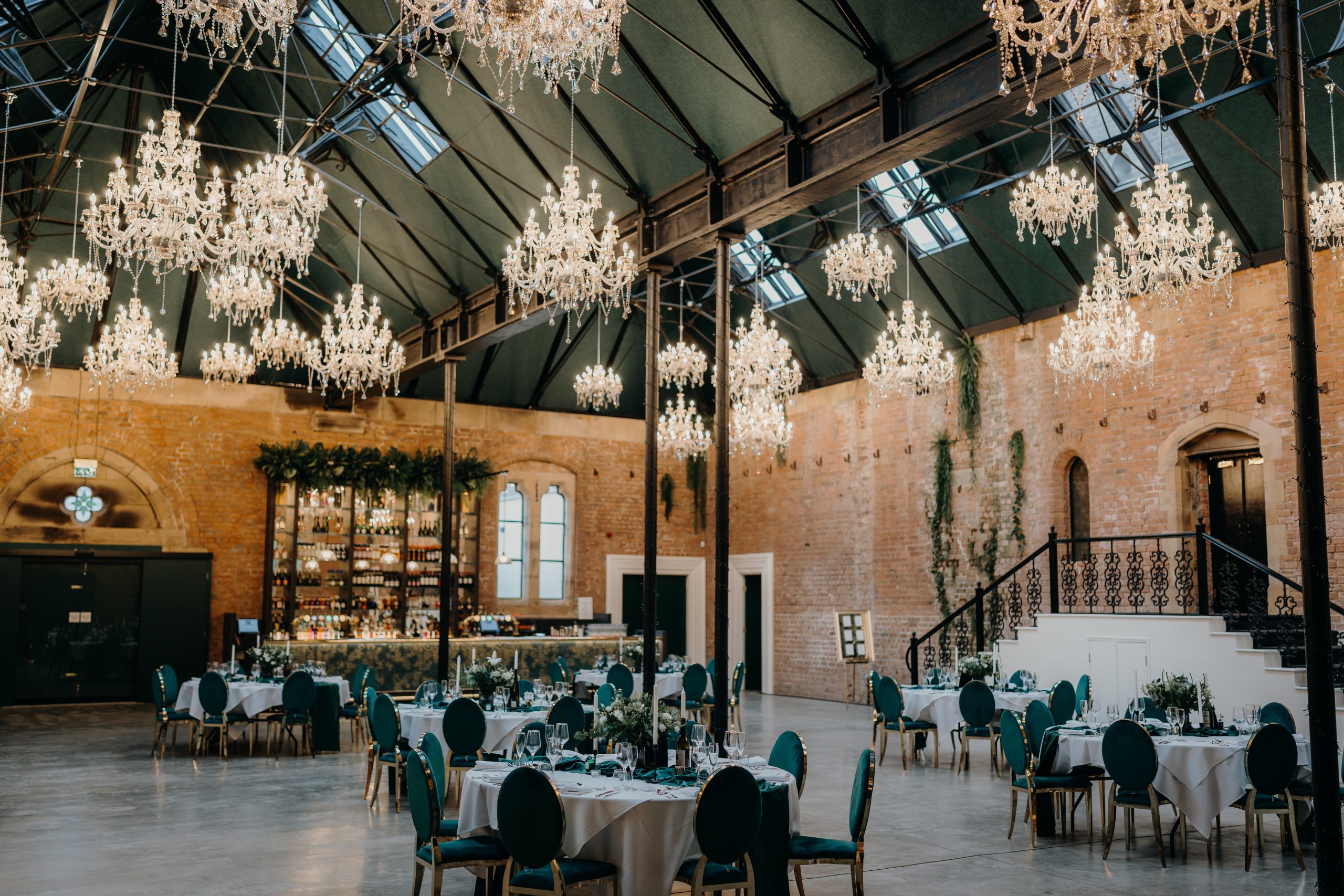 Elegant event space with chandeliers, ideal for weddings and corporate events.