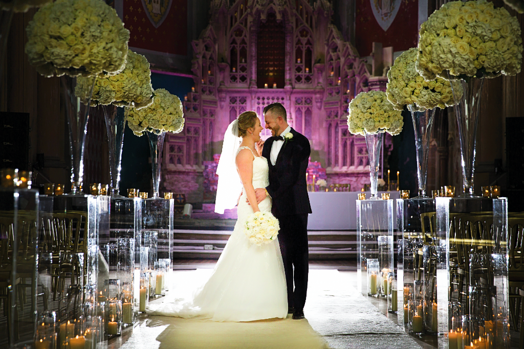 Elegant wedding ceremony at Manchester Monastery with floral decor and modern design.