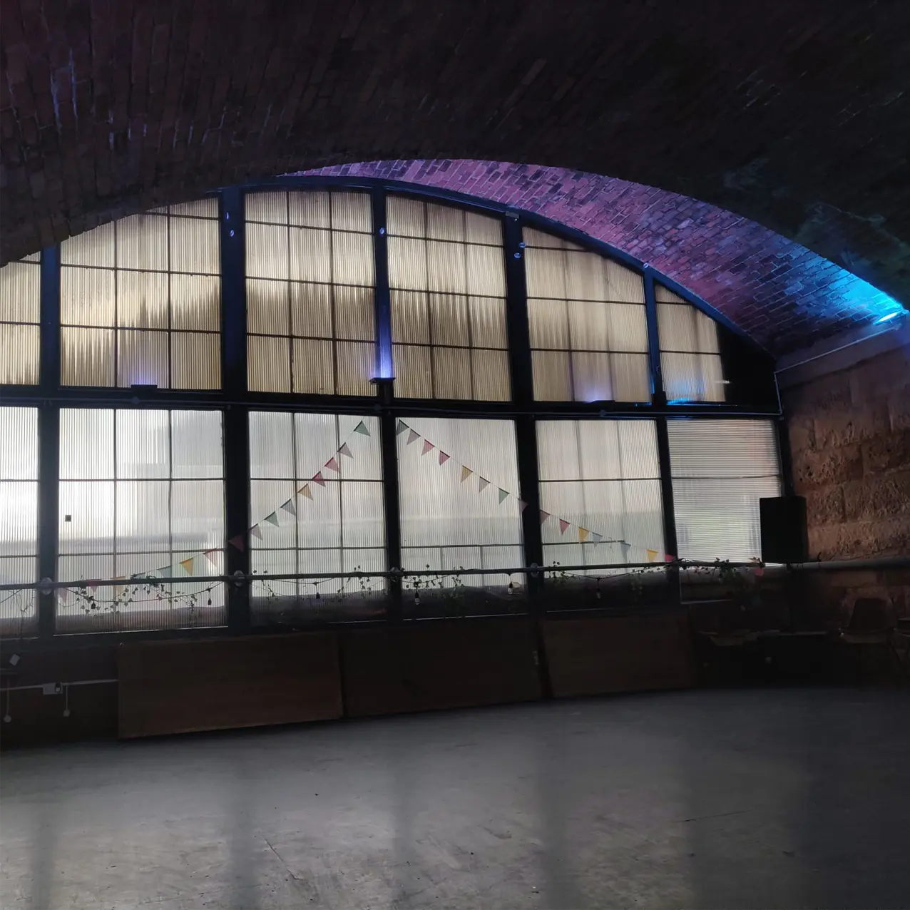 Spacious Mezzanine Level at Leith Arches with arched windows for events and celebrations.