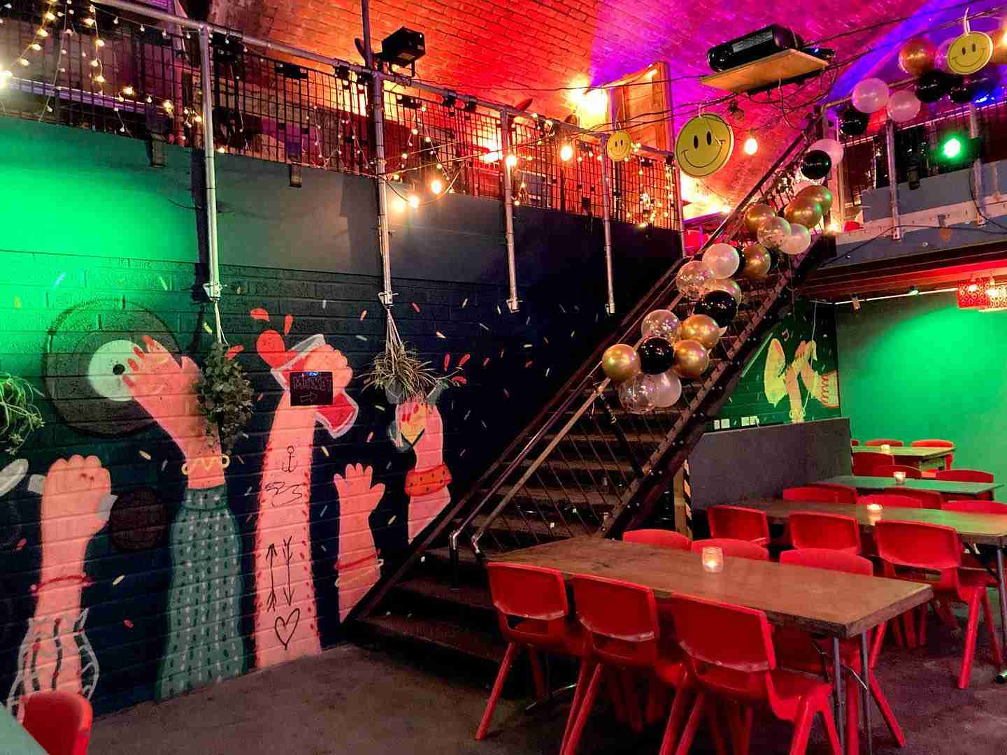 Vibrant Secret Garden event space with colorful murals, ideal for parties and gatherings.
