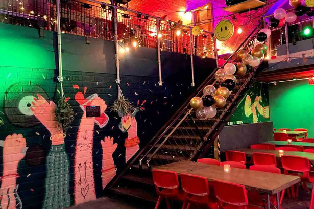 Vibrant event space in Leith Arches with colorful murals and festive decor.