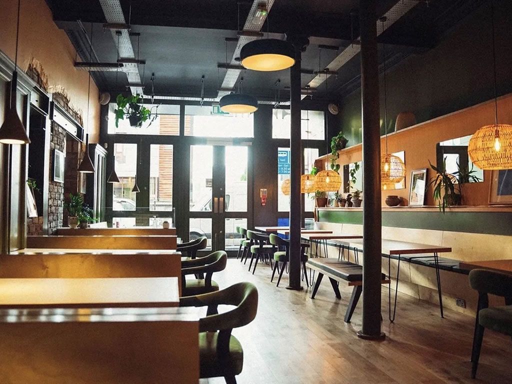 Modern restaurant with warm lighting, ideal for casual meetings and small events.