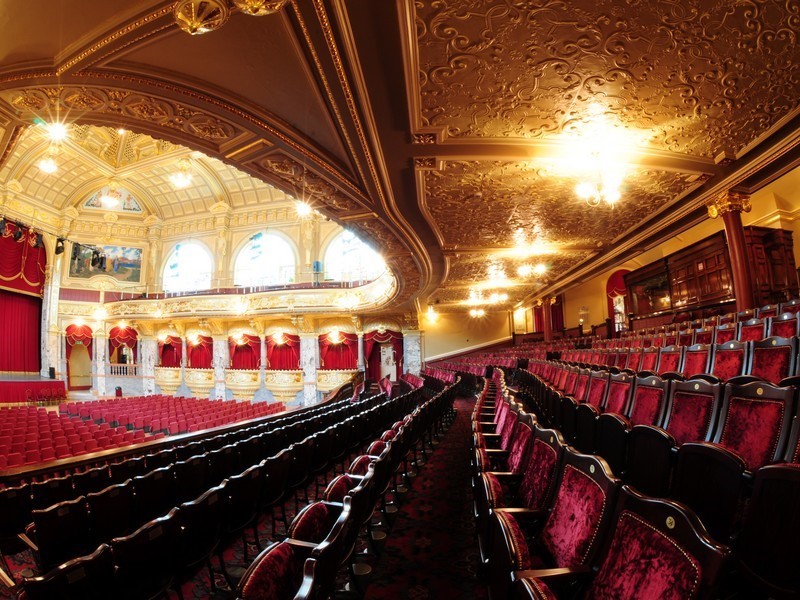 Ornate theater with plush red seating at Harrogate Convention Centre for elegant events.