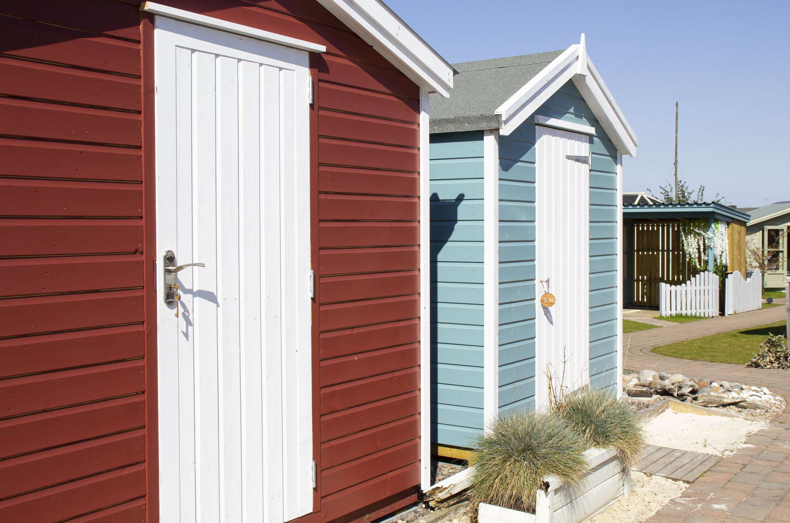 Colorful beach huts at The Cotton Sheds, ideal for outdoor events and team-building activities.