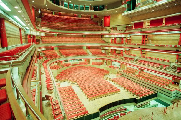 Symphony Hall auditorium with tiered red seating for conferences and performances.