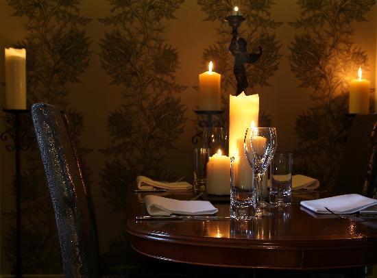 Elegant private dining room with candlelit table for intimate gatherings and events.
