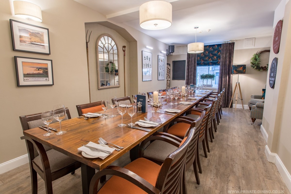 Private dining room with elegant wooden table, ideal for intimate meetings and events.