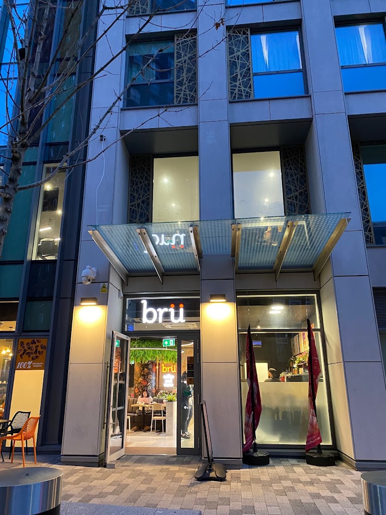 Modern Bru Coffee venue entrance with glass awning, ideal for events and gatherings.