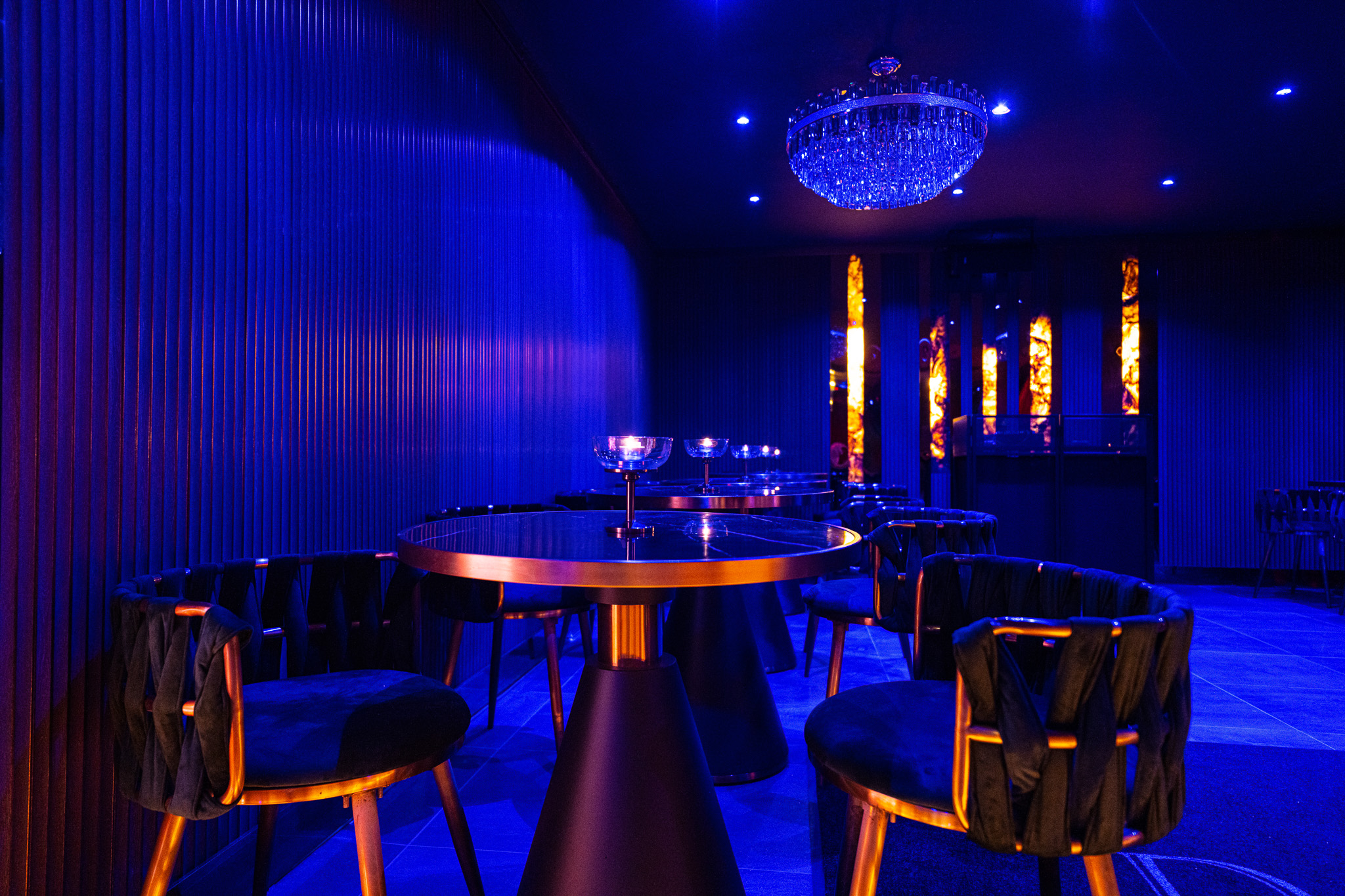 Elegant Daark Venue with blue tones, chandelier, perfect for upscale events and gatherings.