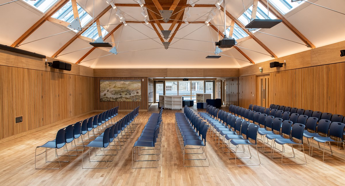 Breakout room with blue chairs, ideal for conferences and workshops.