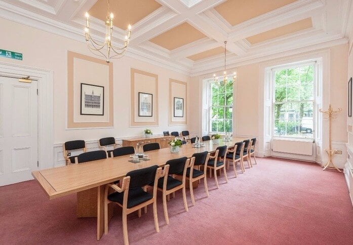 Meeting room in Inigo Edinburgh with wooden table, ideal for corporate events and workshops.