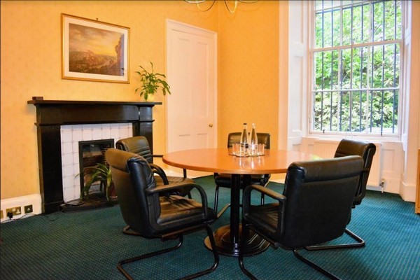 Meeting room in Inigo Edinburgh with round table, ideal for team meetings and consultations.
