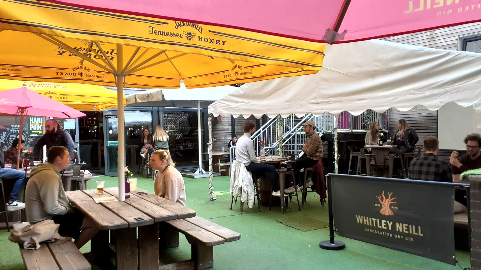 Vibrant Beer Garden with colorful umbrellas, perfect for outdoor events and networking.