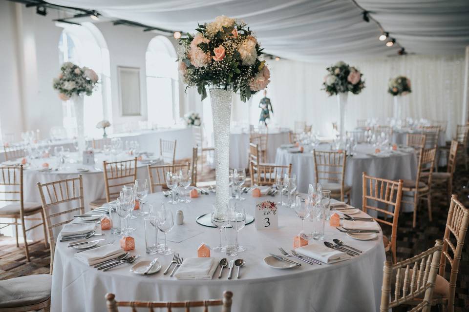 Elegant banquet hall with floral centerpieces for weddings and formal events.