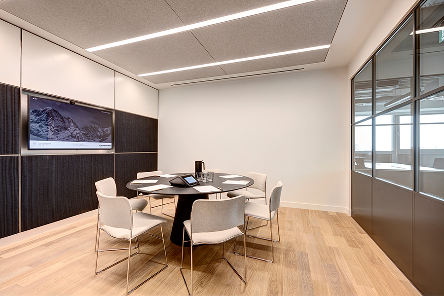 Modern meeting room with round table for collaborative conferences and presentations.