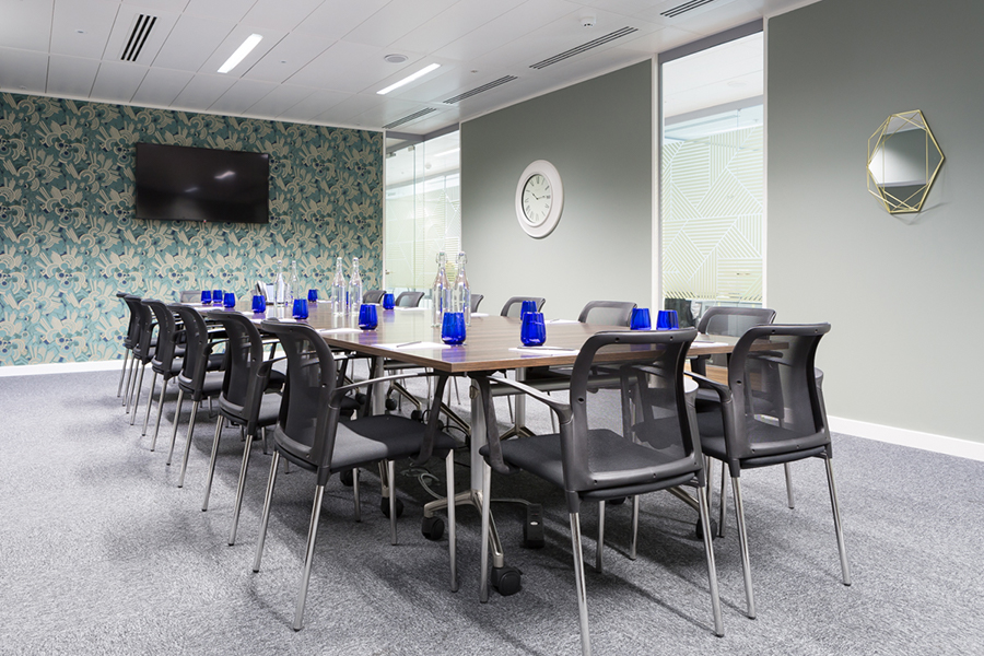 Modern meeting room with long table, ideal for conferences and collaboration.