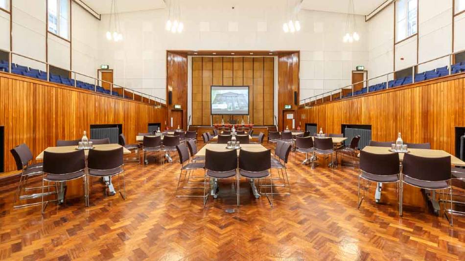 Versatile event space with polished wooden floor for conferences and receptions.