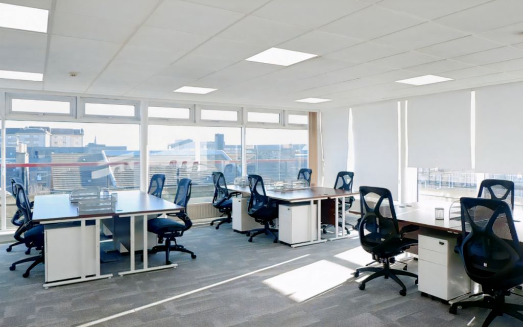 Modern serviced office space with ergonomic workstations for workshops and meetings.
