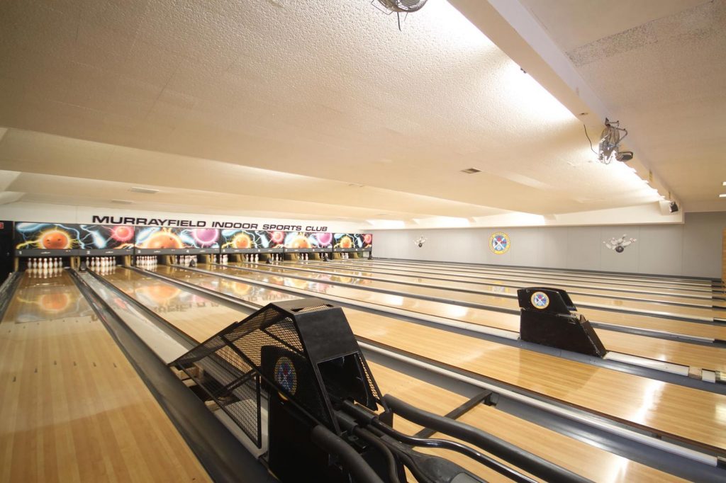 Vibrant bowling alley at Murrayfield Indoor Sports Club for team-building events.