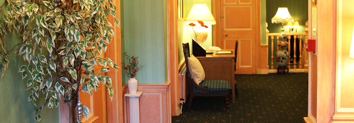 Classic Room reception at Grosvenor Gardens Hotel, warm decor for events and gatherings.